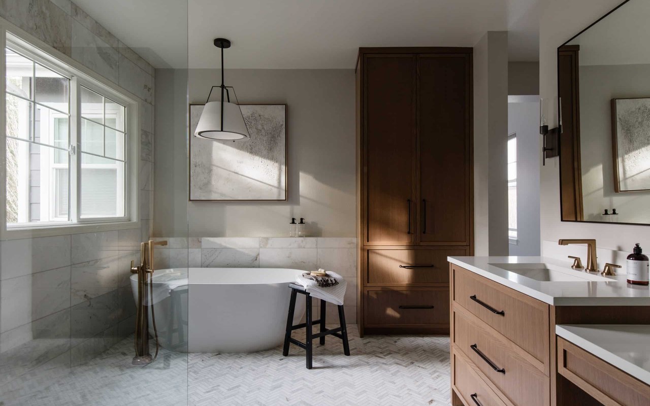 Serene spa bathroom remodel with freestanding tub and oak vanity for Bathroom Remodeling Services